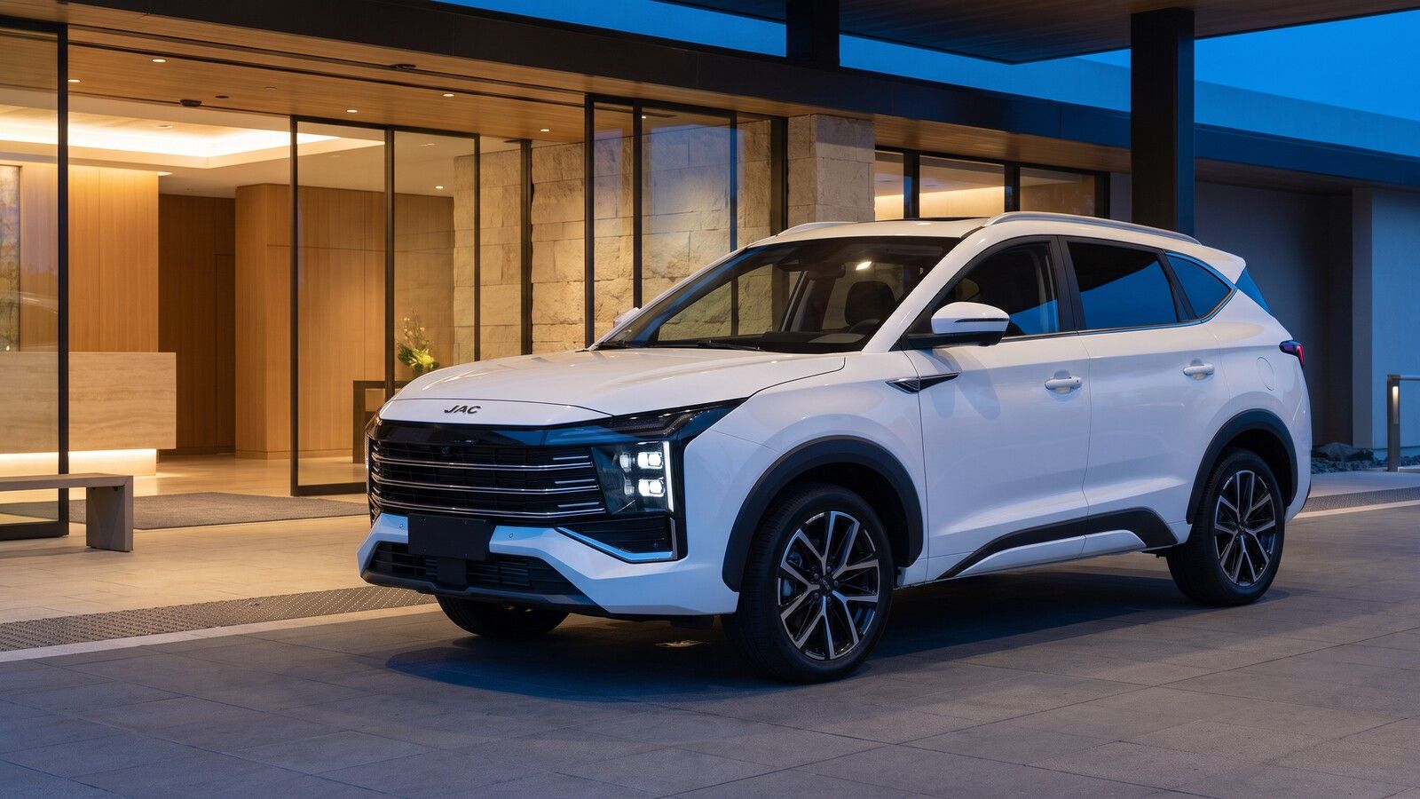 JAC Sei4 Pro at a hotel entrance at dusk.