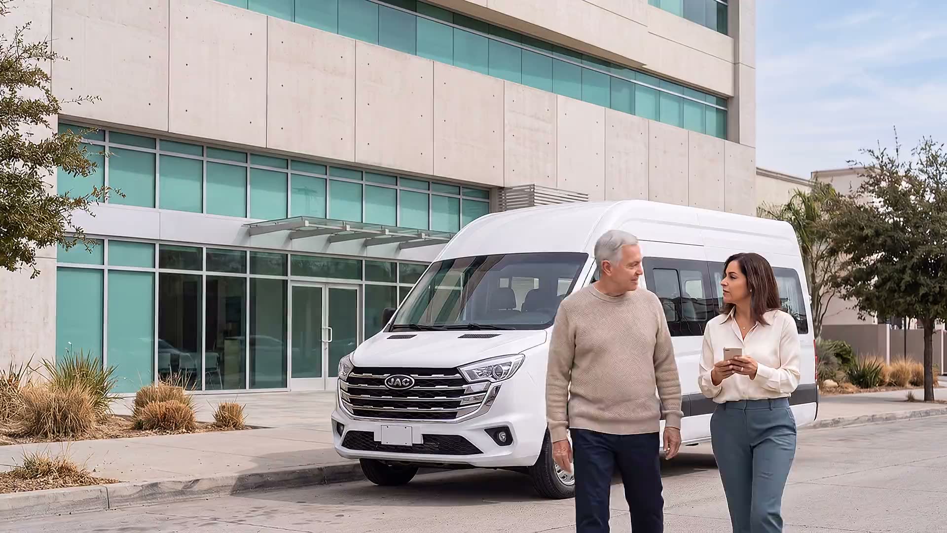 An older adult and a companion walking beside a JAC Sunray outside a clinic in Zona Río, Tijuana.